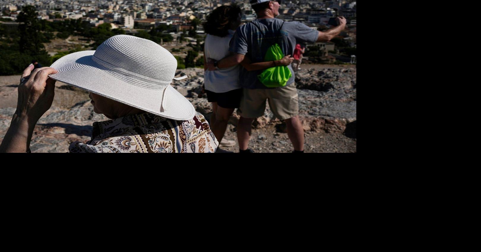 The sunhat is everywhere in Athens as crowds grow larger at ancient sites