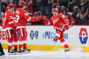 Kane scores twice to lead Red Wings over Flames 5-2 a in milestone night