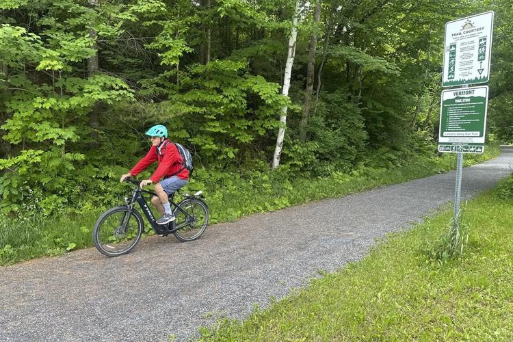 Hikers and cyclists can now cross Vermont on New England's longest rail trail, a year after floods