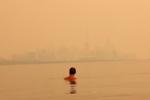 Toronto turns orange under a sky choked by Ontario wildfire smoke: ‘Is this the apocalypse?’