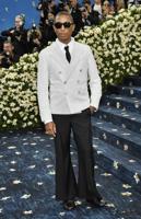 The Latest: The Met Gala opens as rain fails to dim the stars for fashion's biggest night