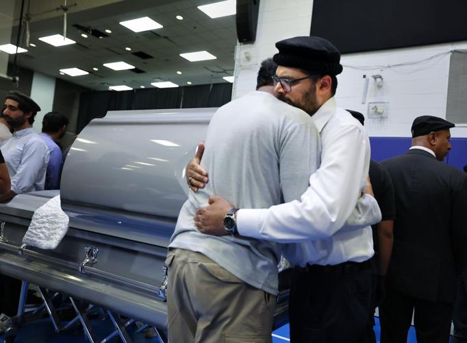 Funeral brother comforted.JPG