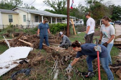 Armies of Texas volunteers dig out, clean up, after fatal floods
