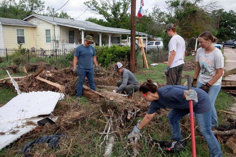 Armies of Texas volunteers dig out, clean up, after fatal floods