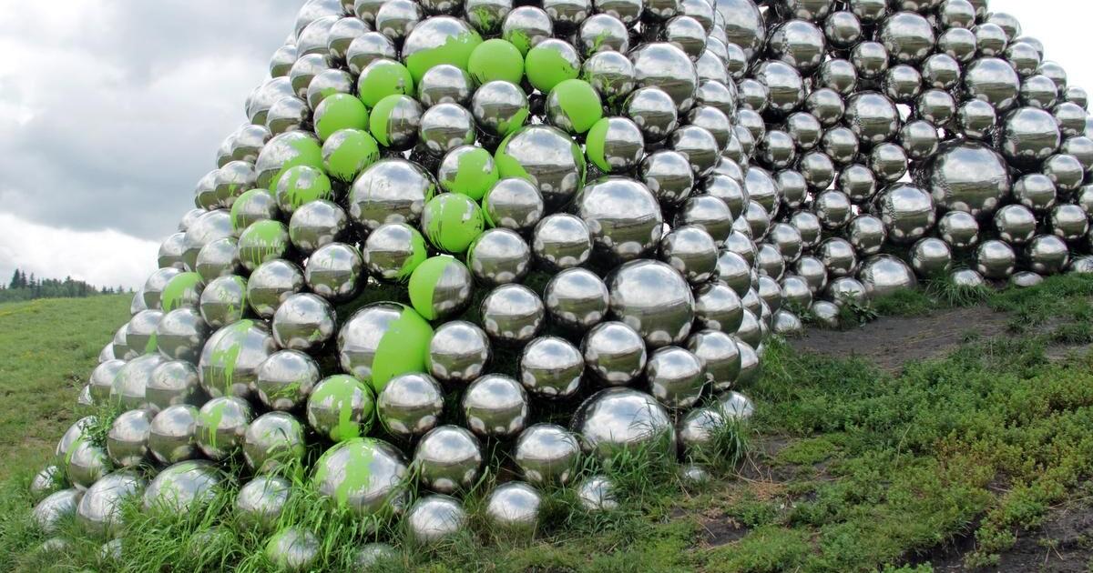 Controversial art installation Talus Dome silver balls covered in lime