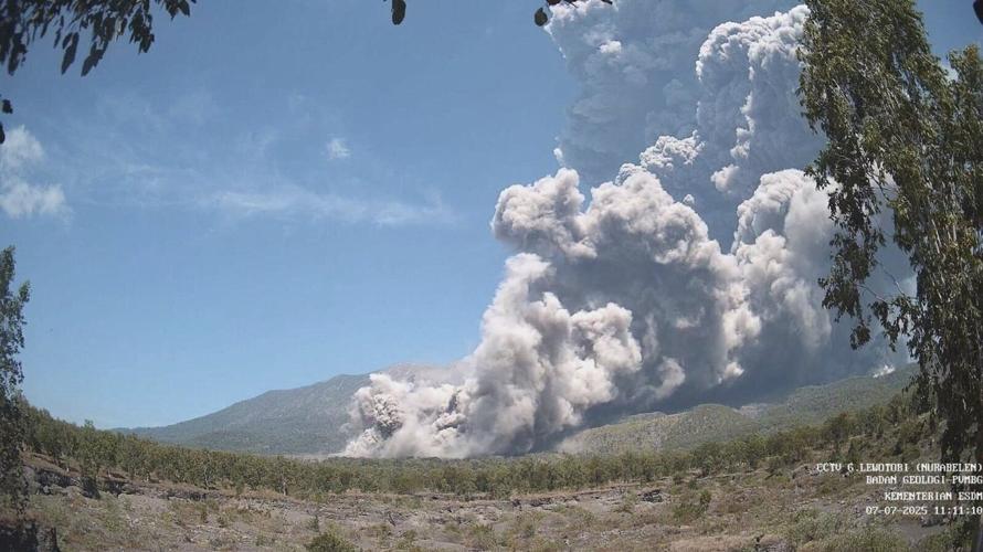 Residents wear masks as volcanic ash blankets villages near erupting Indonesian volcano