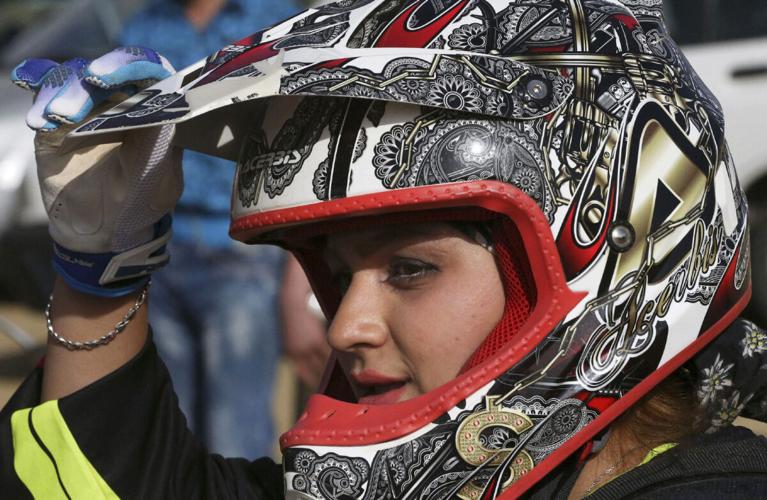 Female motocross racer jumps barriers in Iran