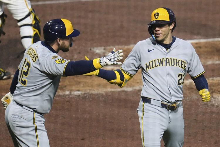 Yelich homers twice and the Brewers hold off the Pirates 8-5 after a long rain delay
