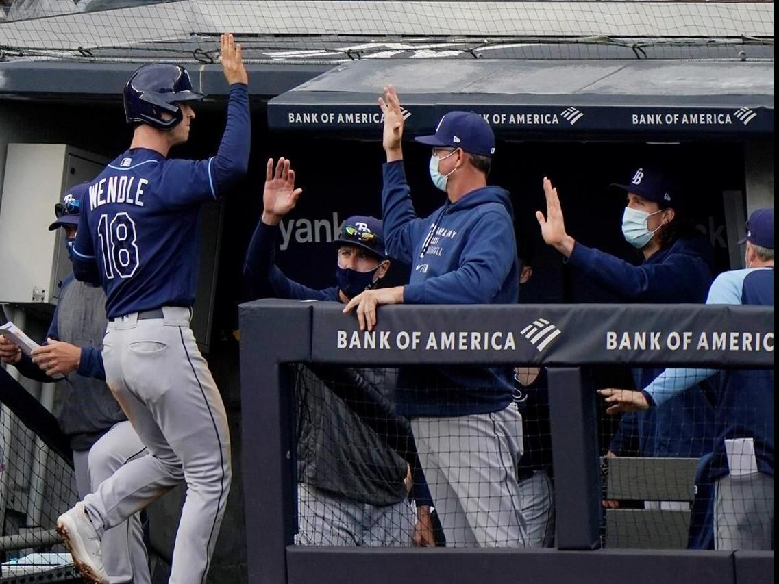 Tampa Bay Rays' Brett Phillips is greeted in the dugout after