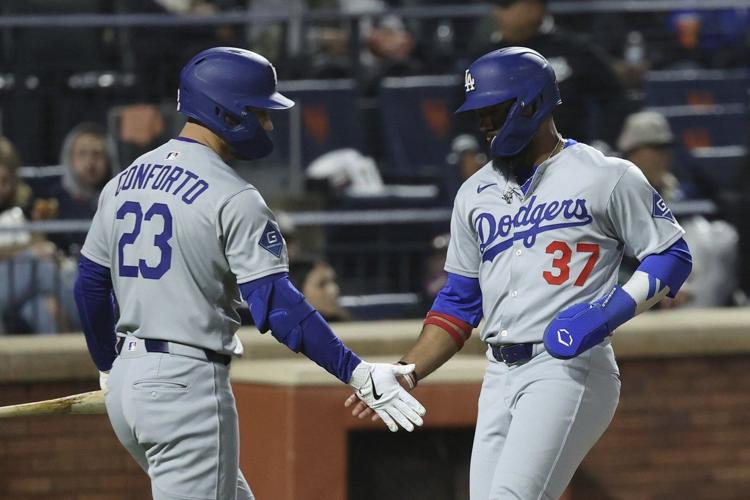 Hernández sends Dodgers past Mets 7-5 in 13 innings in wild and rainy NLCS rematch
