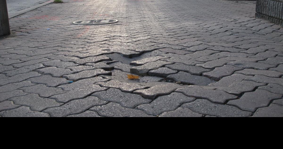 The Fixer Sunken brick in Queens Quay sidewalk hard to see at night