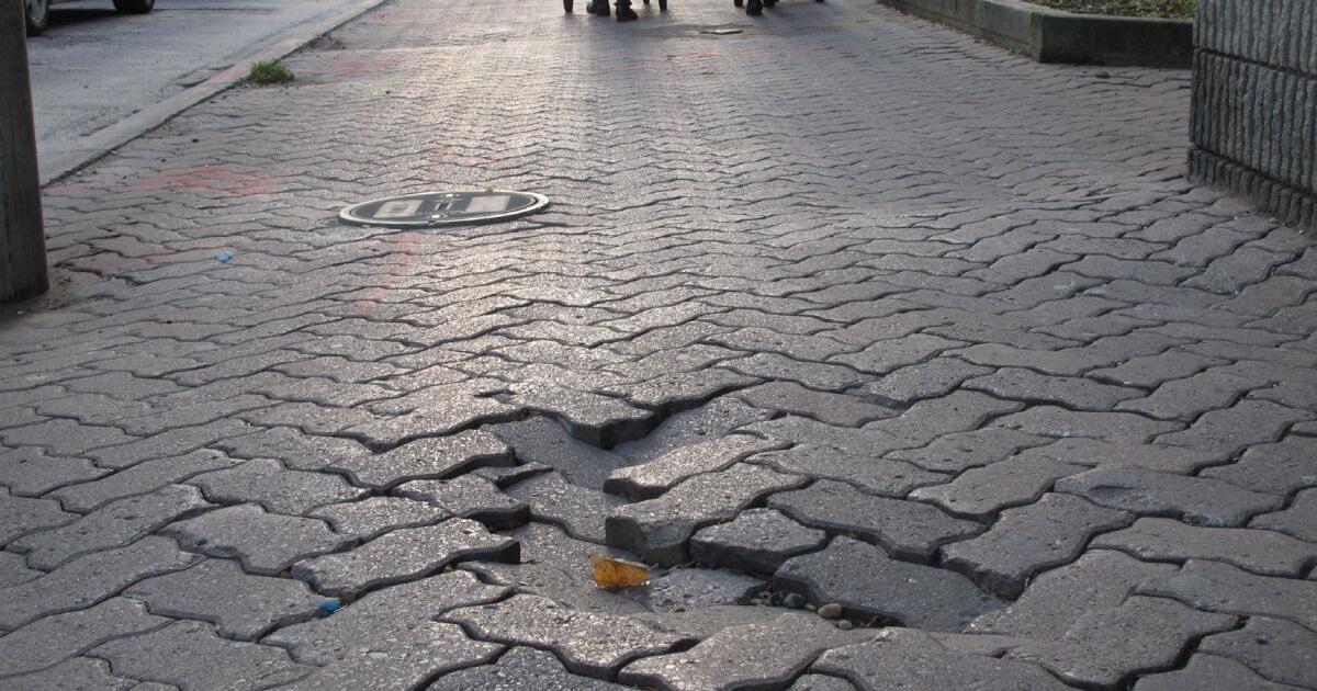 The Fixer Sunken brick in Queens Quay sidewalk hard to see at night