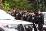Police officers honour fallen colleague Marc Pinizzotto along funeral procession