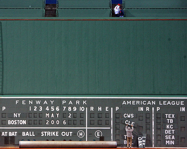 Boston, Massachusetts, USA. April 19, 2012. Dozens of Red Sox fans sit in  the Green Monster Seats at Fenway Park on its 100th Anniversary Open House  whilst hundreds walk on the warning