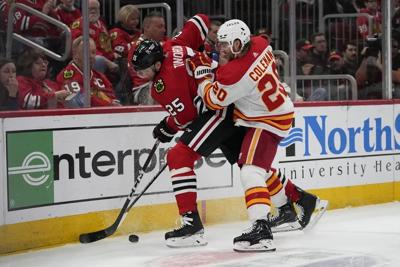 Blackwell helps the Blackhawks beat the Flames 4-3 in first game without Bedard