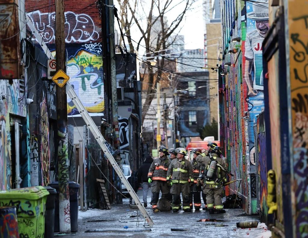 Three people rescued from roof of a building after three-alarm