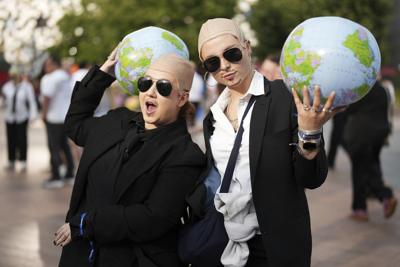White shirts. Black ties. Bald caps. Pitbull’s fans party like clones worldwide