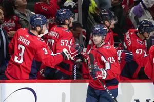 Phillips scores against old team, Capitals beat Flames 3-2 in shootout