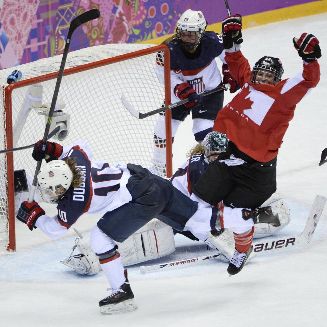 USA defenseman Anne Schleper (15) cross checks Canada forward Jayna Hefford  (16) in the second period of the women's hockey gold medal game at the  Bolshoy Ice Dome during the Winter Olympics