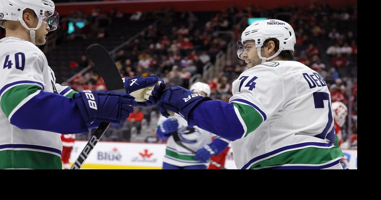 Jake DeBrusk scores hat trick, including OT game-winner, as Canucks top Red Wings 5-4
