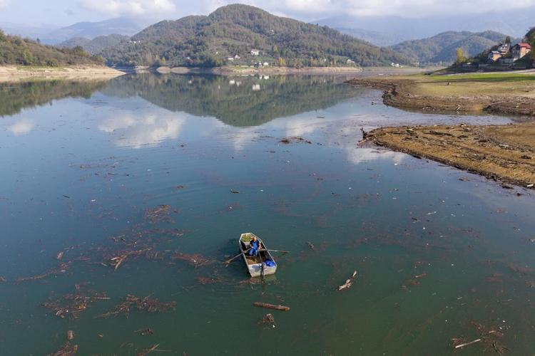 Residents and activists in central Bosnia clean up a lake after massive