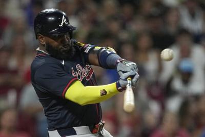 Ozuna's sacrifice fly in 10th gives Braves 12-11 win over Reds