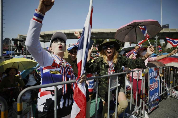 Protesters in Bangkok demand resignation of court-suspended prime minister following deadly conflict