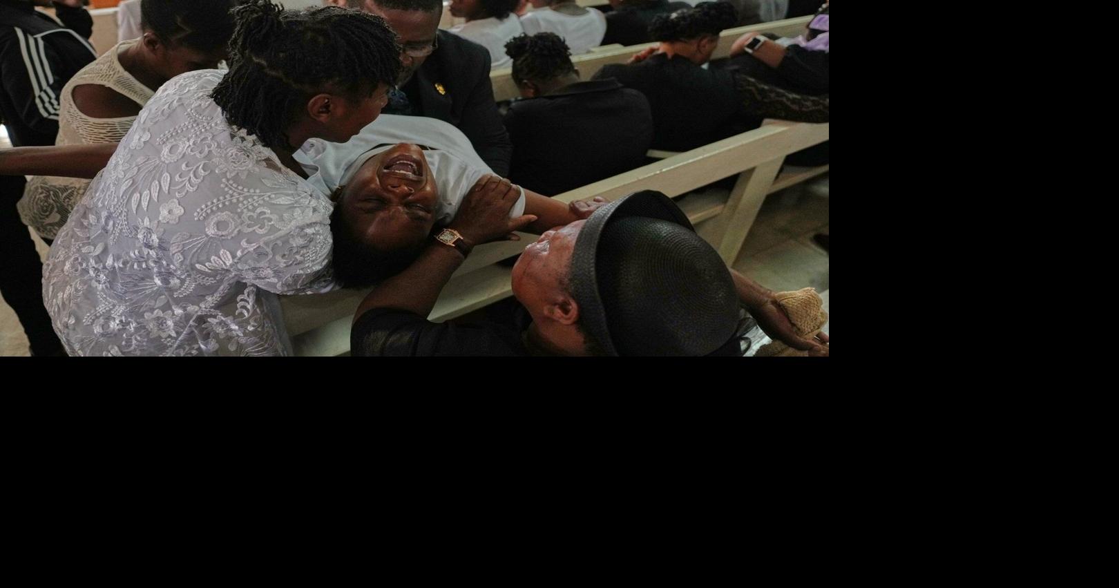 Mourners file into a church in Haiti where gangs killed dozens of people in latest rampage