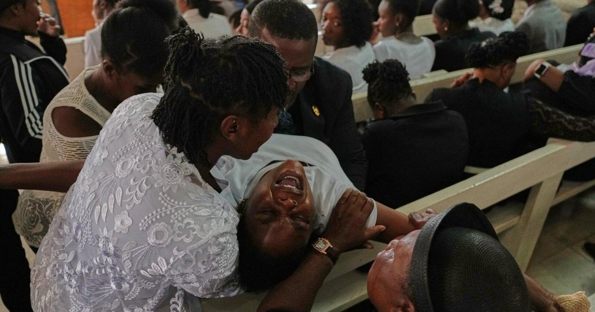 Mourners gather at a church in Haiti following gang violence that killed dozens. Mourners gather at a church in Haiti following gang violence that killed dozens.