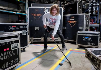 Gil Moore posing with stick and puck (horizontal).jpg