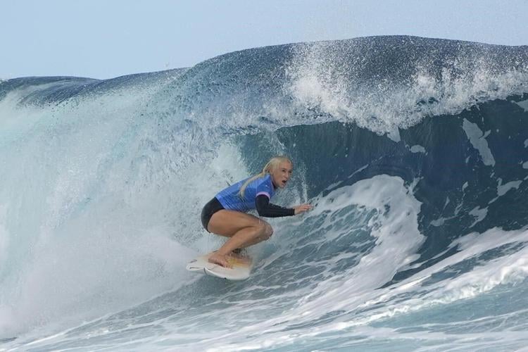 Defending women's champion loses as Olympic surfing competition resumes