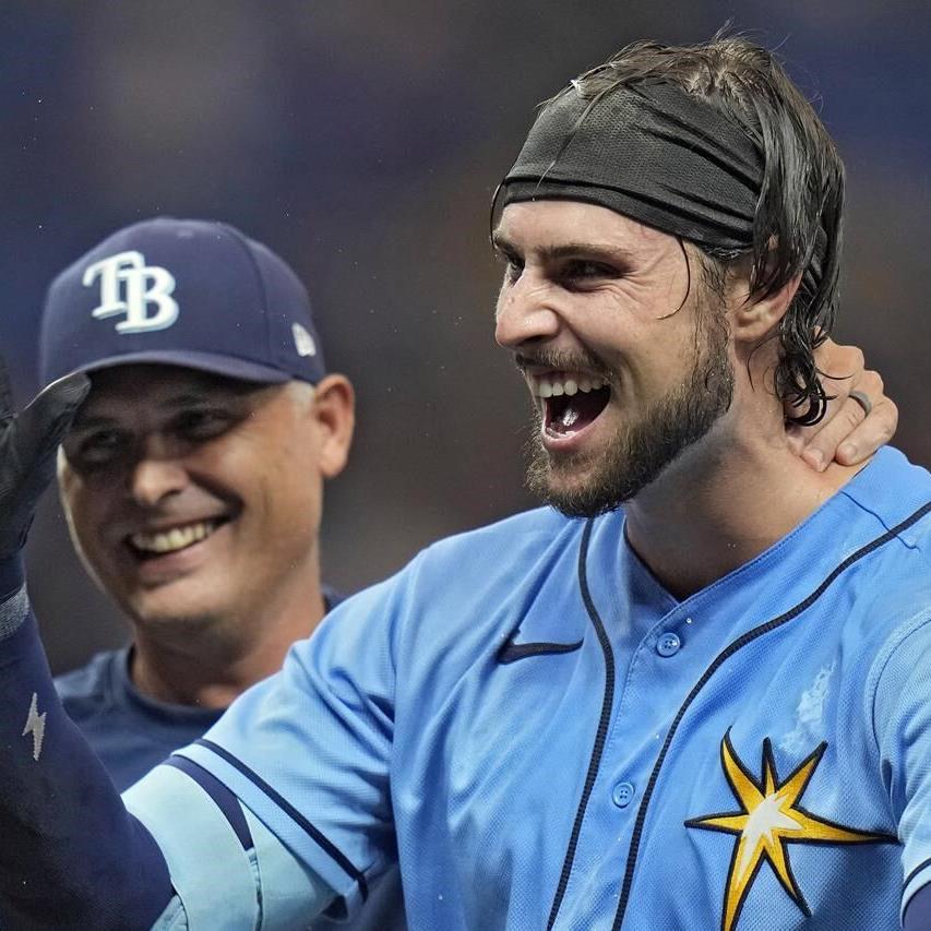 Tampa Bay Rays' Josh Lowe, left, tugs on the jersey of his brother