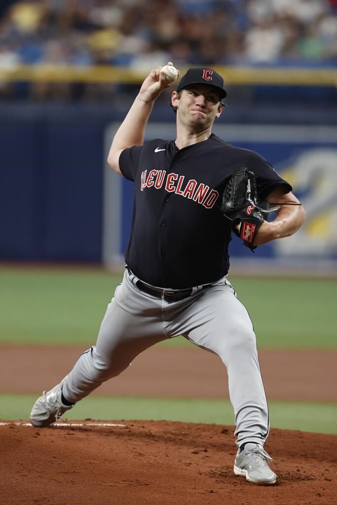 Tampa Bay Rays' Randy Arozarena is congratulated by teammates after scoring  the in the ninth inning of a baseball game against the Cleveland Indians,  Friday, July 23, 2021, in Cleveland. (AP Photo/Tony