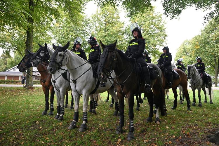 Dutch riot police break up far-right protest in The Hague after ...