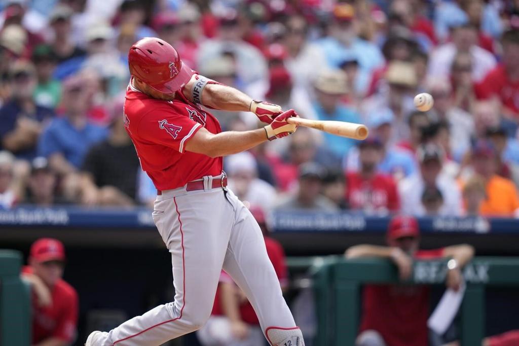 St. Louis Cardinals Harrison Bader removes his batting gloves