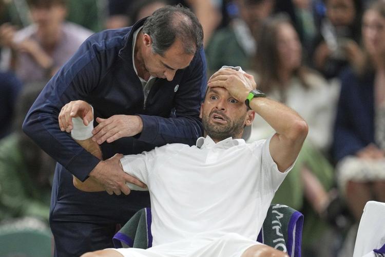 Jannik Sinner reaches the Wimbledon quarterfinals despite a bad elbow when an injured Dimitrov stops