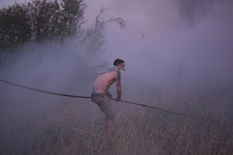 Crews battle scattered fires in Athens suburbs, helped by calmer winds