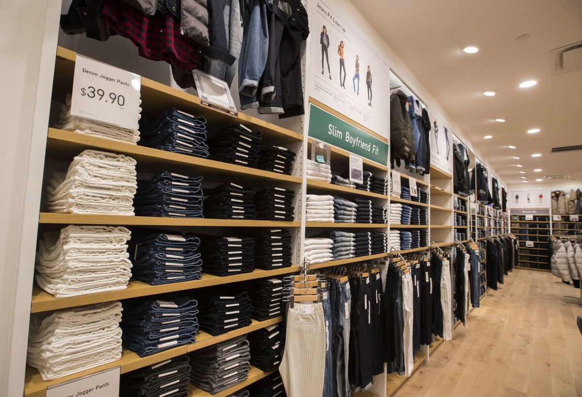 Cropped Shot Of Womans Hand Selecting A Pair Of Trousers From The Display  Shelf While Shopping In A Clothing Store In The City High-Res Stock Photo -  Getty Images