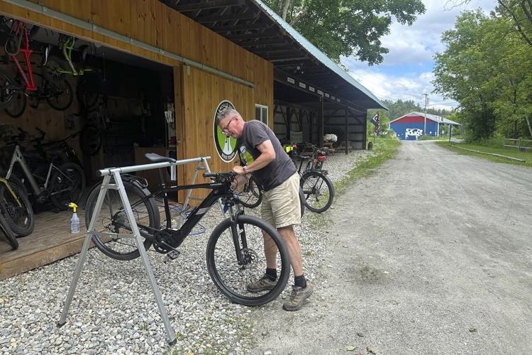 Hikers and cyclists can now cross Vermont on New England's longest rail trail, a year after floods