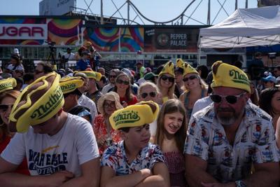 Photos show revelers and competitors alike savoring a July Fourth hot dog eating contest