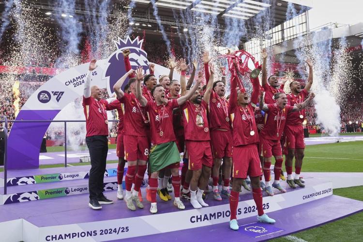 Liverpool players raise Premier League trophy in front of Klopp