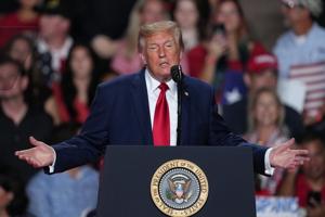 The Latest: Trump interrupted by protesters as he campaigns for Paxton in US Senate race in Texas