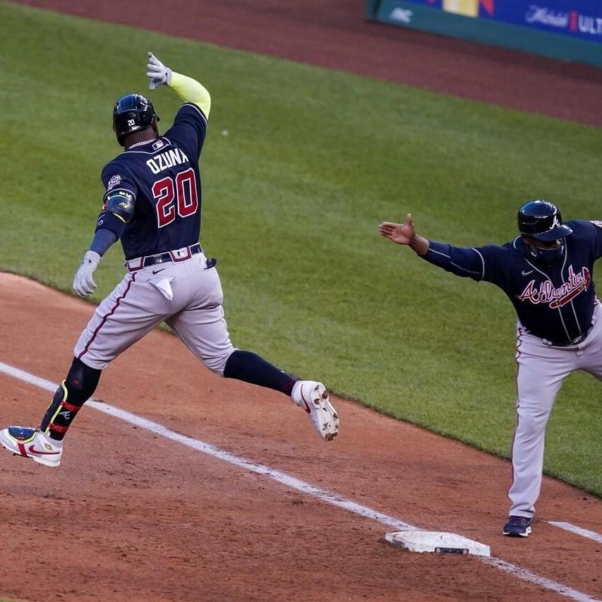 FILE - Atlanta Braves' Freddie Freeman smiles after scoring on a hit by  Marcell Ozuna against the Los Angeles Dodgers during the sixth inning in  Game 4 of a baseball National League