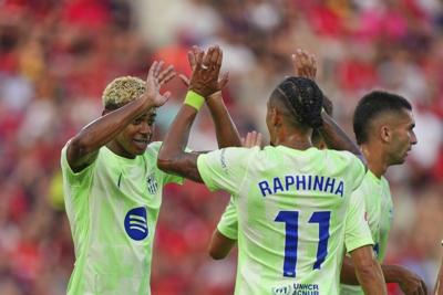 Raphinha and Yamal score as Barcelona starts La Liga title defense beating 9-man Mallorca