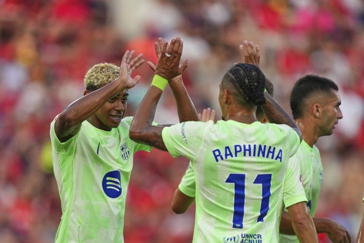 Raphinha and Yamal score as Barcelona starts La Liga title defense beating 9-man Mallorca