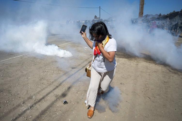 Photos of a confrontation between protesters and federal officials outside California farm