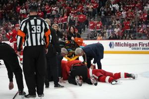 Red Wings' Larkin face-down, motionless on ice for about a minute after cross-check from behind