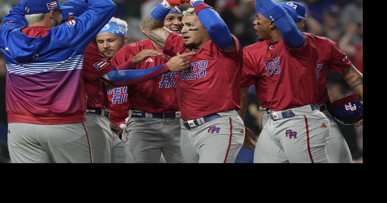 Puerto Rico's Emmanuel Rivera (26) rubs his hair after a hit to center  field during the first inning of a World Baseball Classic game against  Mexico, Friday, March 17, 2023, in Miami.