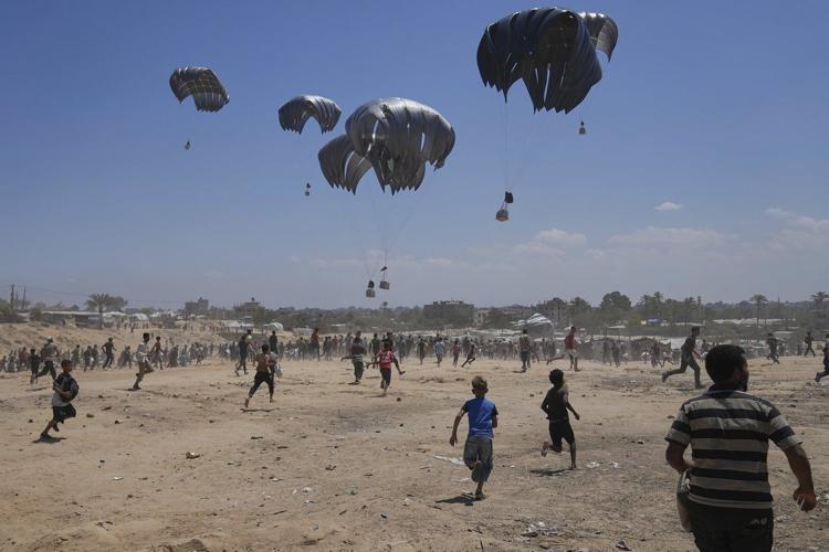 Photos show Palestinians pursuing food aid after the latest air drops in Gaza