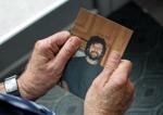 Klein holds pic of himself.JPG